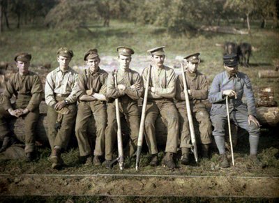 Canadian soldiers with a cant hook are sitting on the trunk of a tree for a sawmill, Quesmy, Oise, France, 1917 by Fernand Cuville